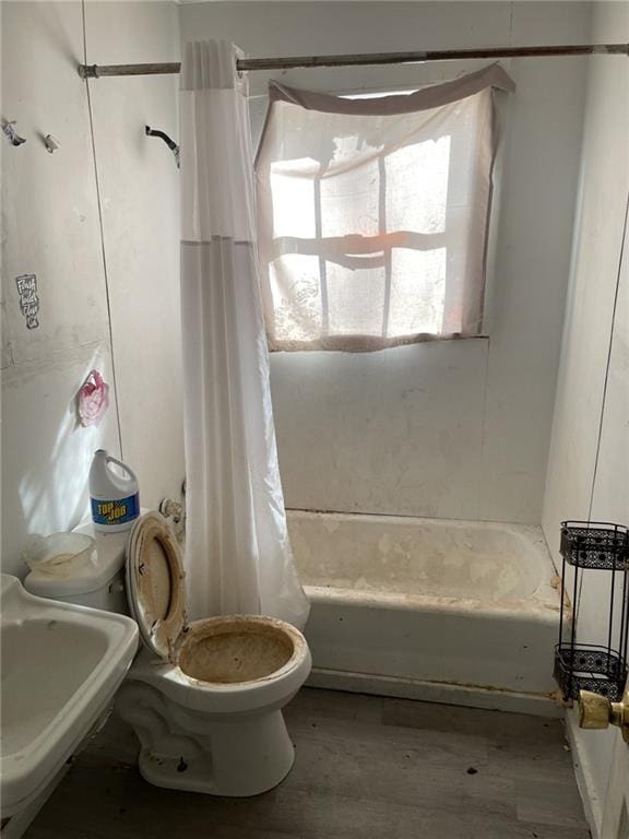 full bathroom with sink, shower / tub combo, and toilet