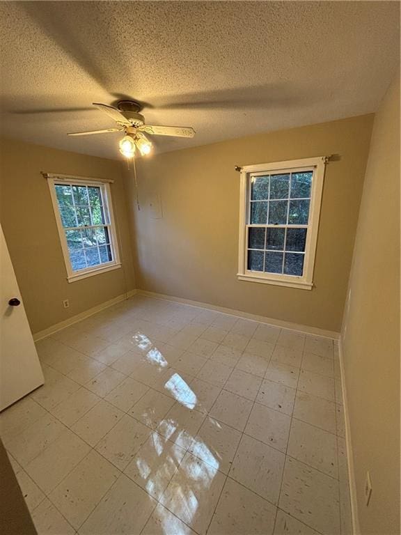 unfurnished room with a textured ceiling and ceiling fan