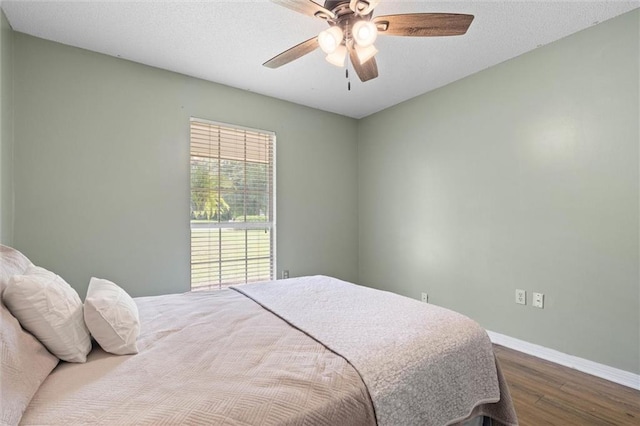 3660 Ching Dairy Rd, Mobile, AL 36618 - bedroom featuring dark wood-style floors, baseboards, and a ceiling fan