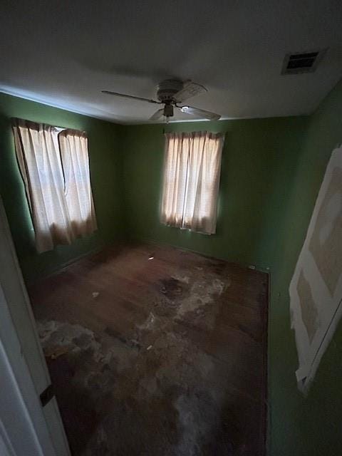 empty room featuring visible vents and ceiling fan