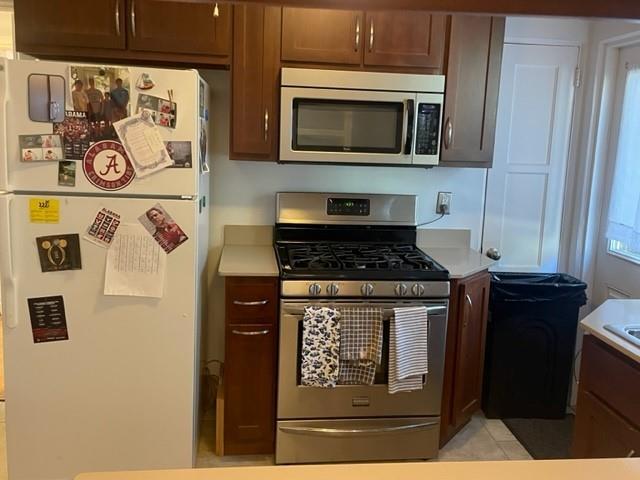 kitchen featuring stainless steel appliances and light tile patterned floors