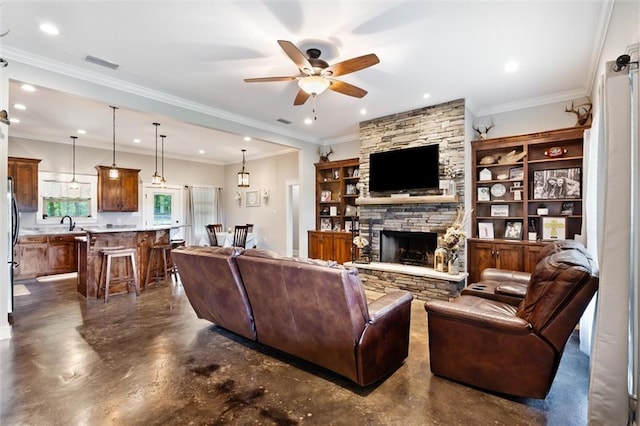 living room featuring a stone fireplace, ceiling fan, and crown molding