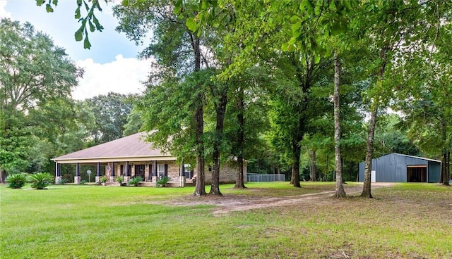 view of yard featuring covered porch and an outdoor structure