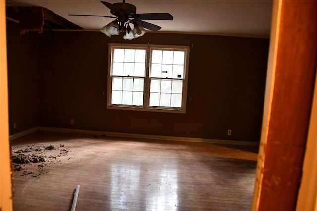 unfurnished room with ceiling fan and wood-type flooring