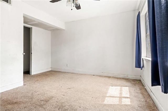 unfurnished room with ceiling fan and carpet flooring