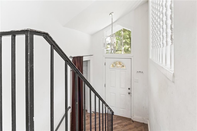 foyer entrance with an inviting chandelier and parquet flooring