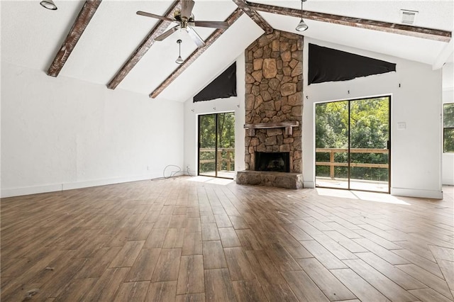 unfurnished living room featuring ceiling fan, hardwood / wood-style floors, high vaulted ceiling, and a fireplace