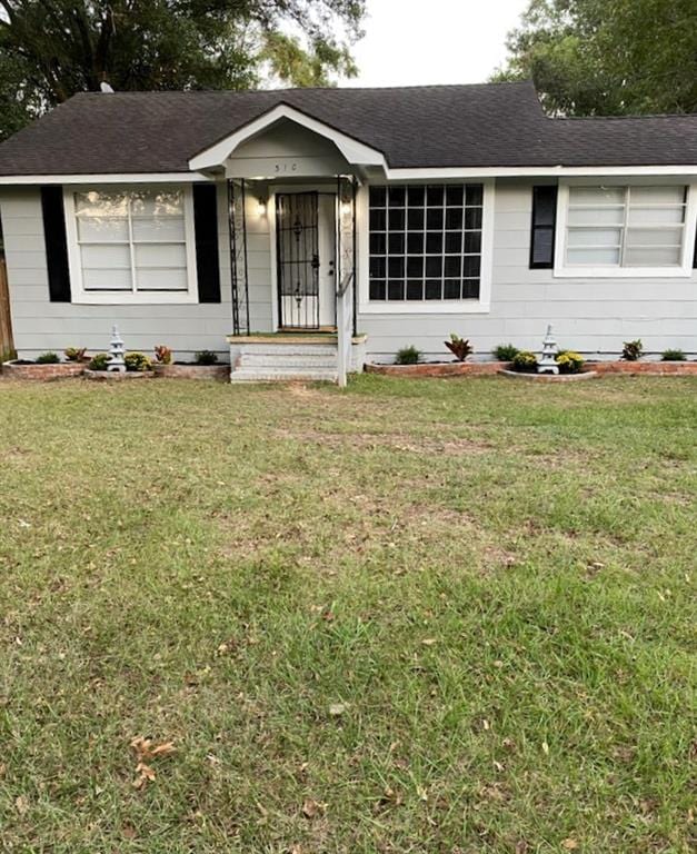 ranch-style house with a front lawn