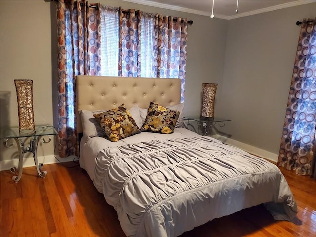 bedroom featuring hardwood / wood-style floors and ornamental molding