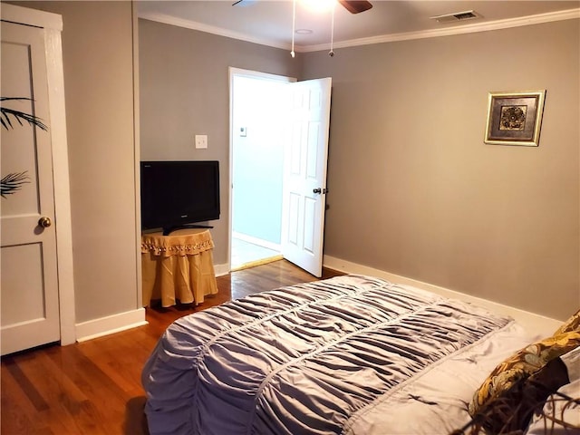 bedroom featuring ceiling fan, ornamental molding, and dark wood-type flooring