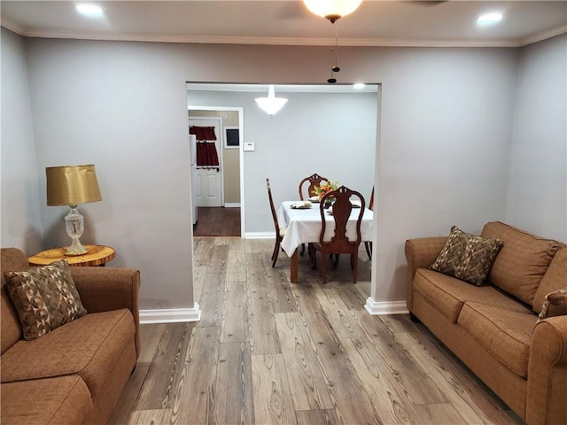 living room with hardwood / wood-style flooring and ornamental molding