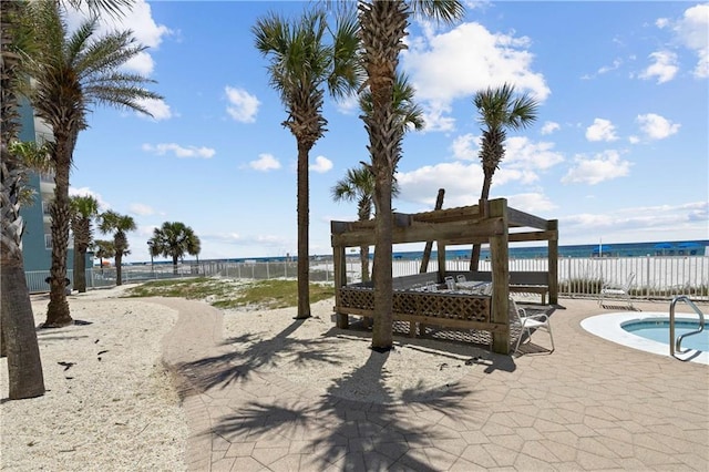 view of community with a swimming pool, a patio, and a water view