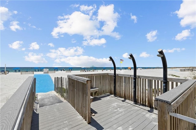 exterior space featuring a beach view and a water view