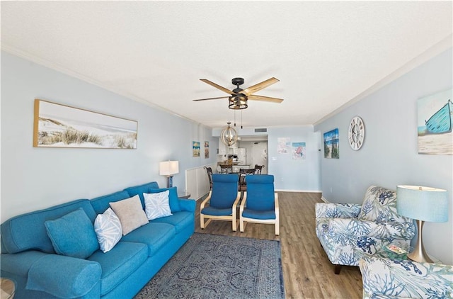 living room with ceiling fan, hardwood / wood-style floors, and crown molding