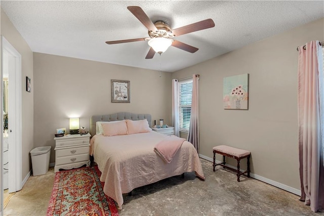 bedroom featuring ceiling fan and a textured ceiling