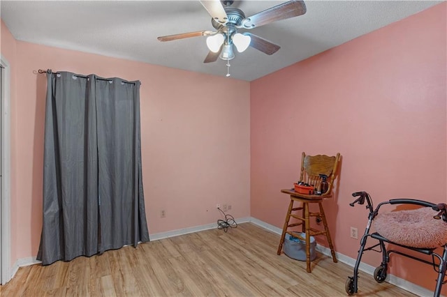 miscellaneous room with ceiling fan and light wood-type flooring