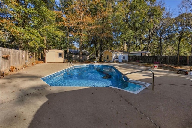 view of pool featuring a storage shed and a patio