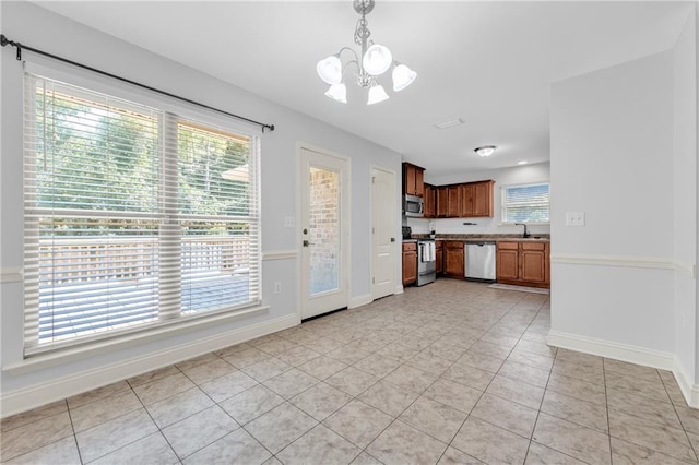 2107 Wolf Branch Dr N, Mobile, AL 36608 - kitchen with stainless steel appliances, a chandelier, a sink, pendant lighting, and light tile patterned floors