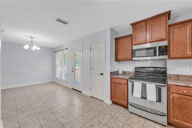 2107 Wolf Branch Dr N, Mobile, AL 36608 - kitchen featuring appliances with stainless steel finishes, a chandelier, and brown cabinetry