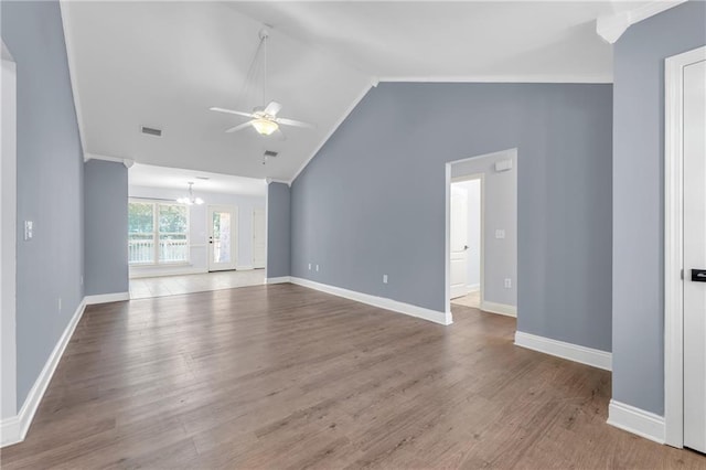 2107 Wolf Branch Dr N, Mobile, AL 36608 - unfurnished living room featuring a chandelier, ceiling fan, vaulted ceiling, wood finished floors, and crown molding