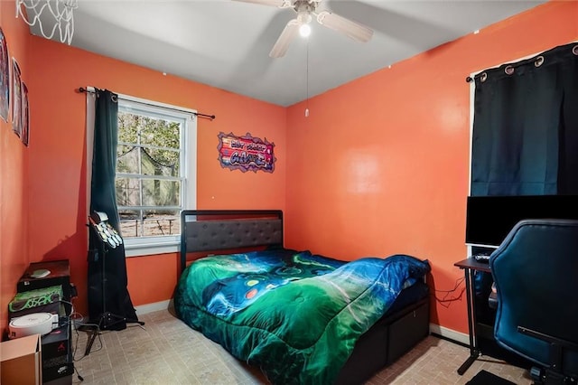 bedroom with ceiling fan, baseboards, and tile patterned floors