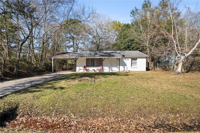 ranch-style house featuring a carport, a front lawn, and concrete driveway