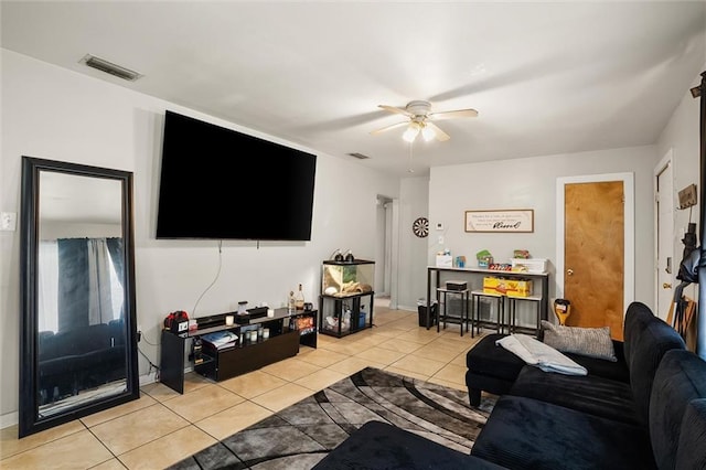 living room with visible vents, ceiling fan, and light tile patterned floors