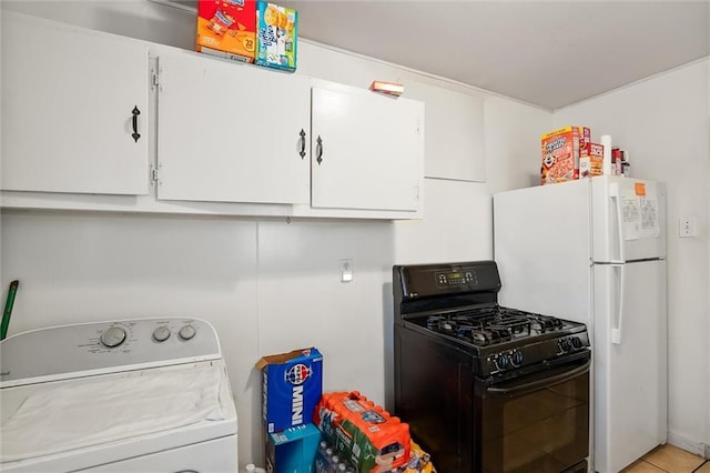 kitchen with washer / dryer, white cabinetry, and black range with gas stovetop