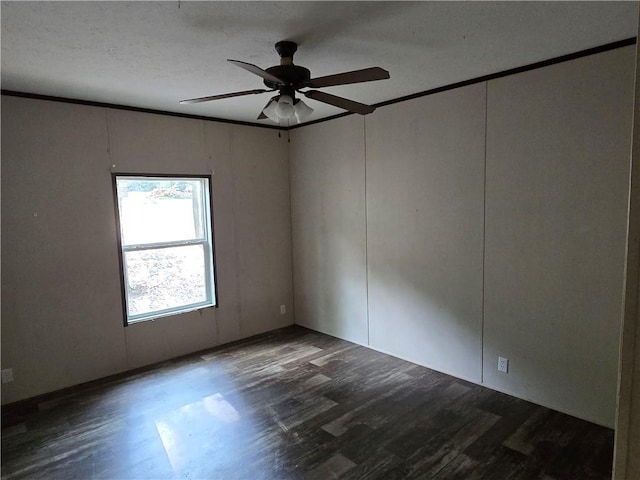 spare room featuring ceiling fan, dark wood-type flooring, and ornamental molding