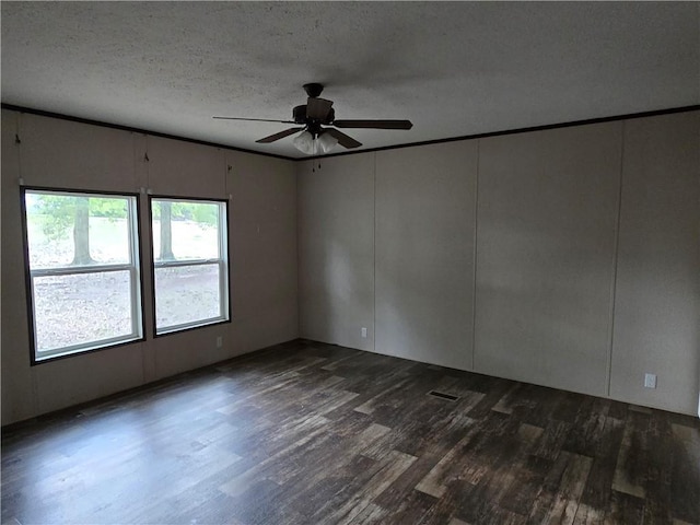 unfurnished room featuring ceiling fan, dark hardwood / wood-style flooring, and a textured ceiling