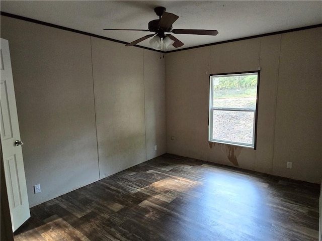 spare room with dark wood-type flooring, ceiling fan, ornamental molding, and a textured ceiling