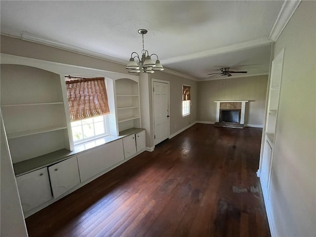 entrance foyer with ceiling fan with notable chandelier, a fireplace, dark hardwood / wood-style flooring, and crown molding