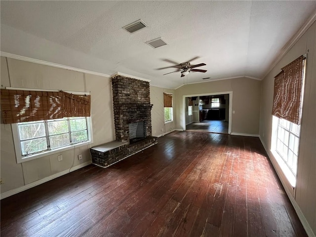 unfurnished living room with a healthy amount of sunlight, hardwood / wood-style flooring, and visible vents