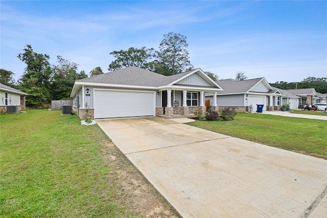 craftsman-style house featuring covered porch, central AC unit, a front lawn, and a garage