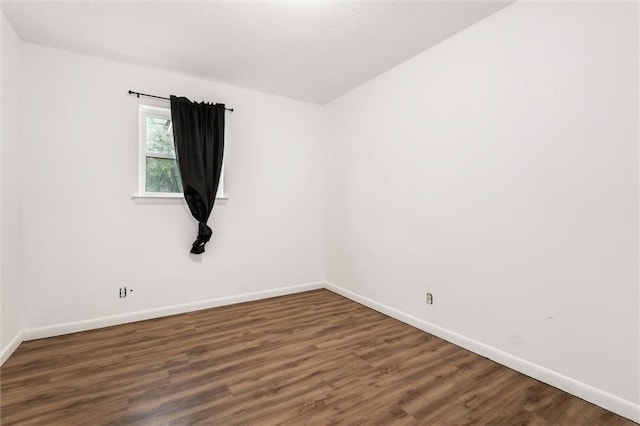 spare room featuring dark hardwood / wood-style floors