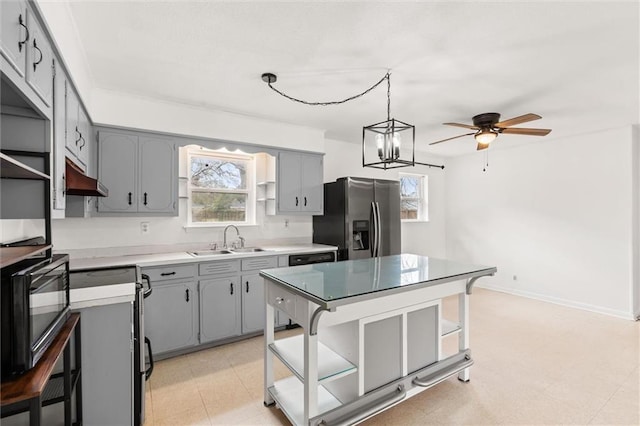 kitchen featuring a kitchen island, decorative light fixtures, sink, gray cabinetry, and stainless steel fridge with ice dispenser