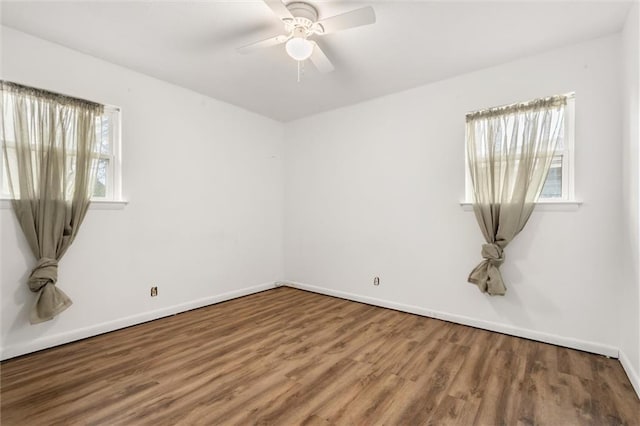 spare room featuring hardwood / wood-style flooring, ceiling fan, and a wealth of natural light