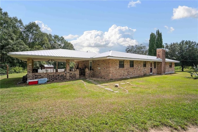 rear view of property with a lawn