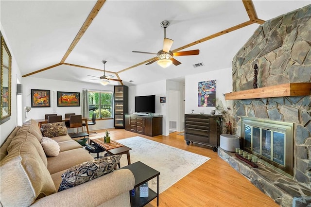 10407 Lala Rd, Daphne, AL 36526 - living area featuring ceiling fan, visible vents, a stone fireplace, wood finished floors, and lofted ceiling