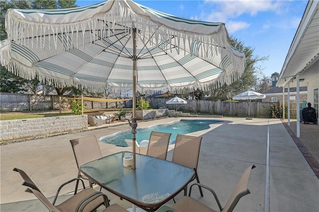 view of swimming pool featuring pool water feature and a patio