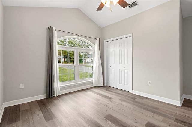 4625 Pine Blvd, Orange Beach, AL 36561 - unfurnished bedroom with lofted ceiling, wood finished floors, a closet, baseboards, and ceiling fan