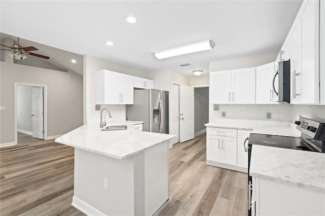4625 Pine Blvd, Orange Beach, AL 36561 - kitchen featuring a sink, appliances with stainless steel finishes, ceiling fan, a peninsula, and tasteful backsplash