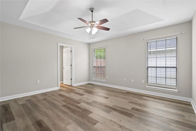 4625 Pine Blvd, Orange Beach, AL 36561 - empty room featuring ceiling fan, wood finished floors, baseboards, and a raised ceiling
