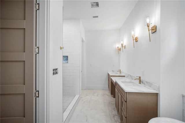 bathroom featuring vanity and tiled shower