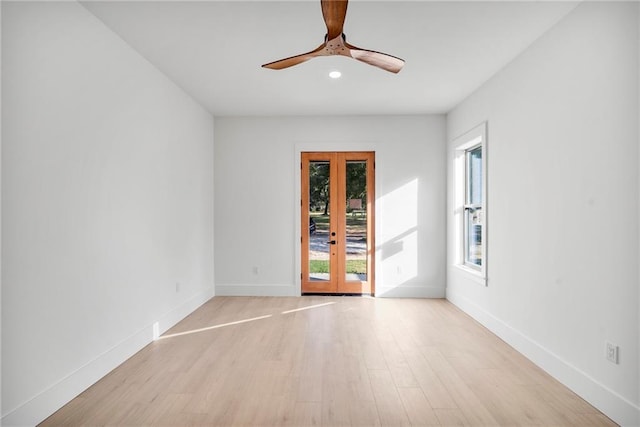 unfurnished room with french doors, light hardwood / wood-style floors, and ceiling fan