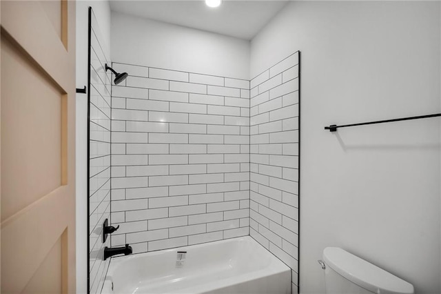 bathroom with toilet and tiled shower / bath combo