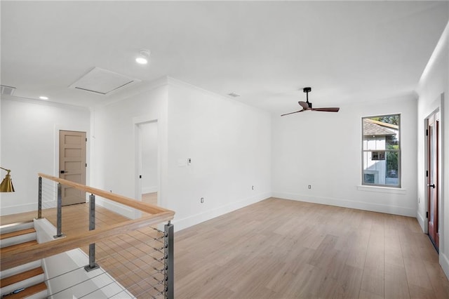 unfurnished room with ceiling fan, ornamental molding, and light wood-type flooring