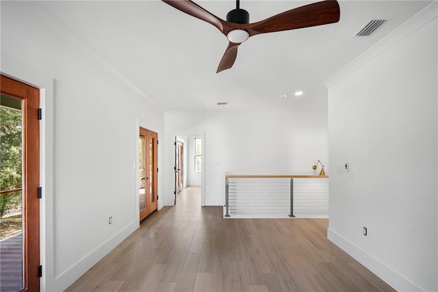 empty room with light hardwood / wood-style flooring and ceiling fan