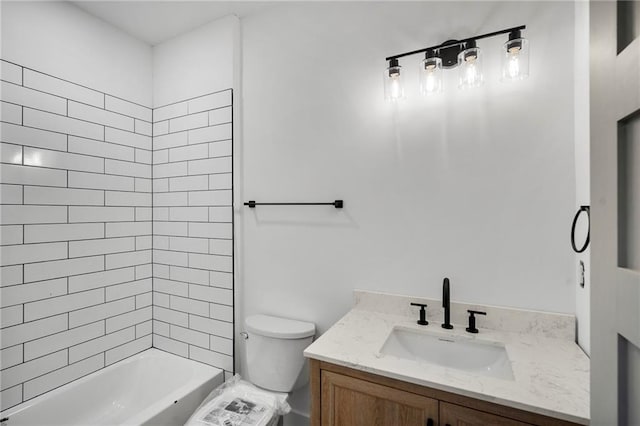 full bathroom with toilet, tiled shower / bath combo, and vanity