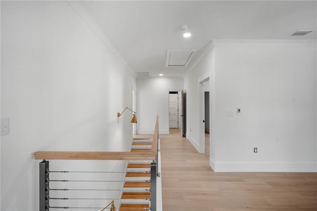 stairs with crown molding and hardwood / wood-style floors